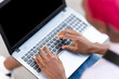 © Iván Moreno - Top view of hands of a woman using a laptop