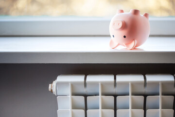 concept energy crisis in europe. upside down piggy bank and heating battery.