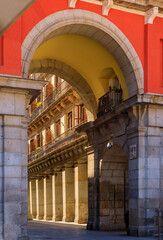 Wall Mural - Gate to the Plaza Mayor surrounded by cafes and restaurants along the arches with a view to Calle de de Ciudad Rodrigo in Madrid, Spain