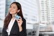 © Mallika - businesswoman holding credit card.