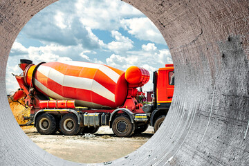 Wall Mural - Concrete mixer truck in front of a concrete batching plant, cement factory. Loading concrete mixer truck. Close-up. Delivery of concrete to the construction site. Monolithic concrete works.