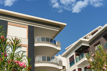 Canvas Print - Image of the exterior of a residential building against a blue sky.