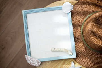 Wall Mural - mockup blue frame with seashell ,hat decor on side table