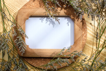 Wall Mural - mockup wooden photo frame on round table with evening sunlight