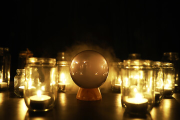 Wall Mural - Black background with a ball and candles. Divination and prediction of fate.