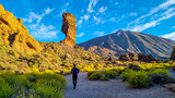 Fototapeta  - Man with backpack hiking with scenic golden hour sunrise morning view on unique rock formation Roque Cinchado, Roques de Garcia, Tenerife, Canary Island, Spain, Europe. Pico del Teide volcano summit
