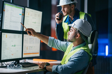 Group of  engineer control process of production uses computer with modern SCADA system which showing AI and machine learning. Team of workers operator follow of industry process on factory