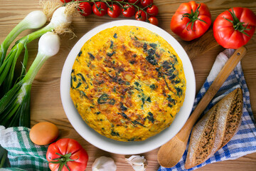 Wall Mural - Spinach and potato omelette. Traditional Spanish tortilla recipe. Top view shot.