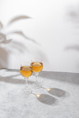 Two glasses of white wine on light background. Wine making and wine degustation concept. Free space for your text