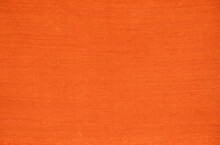 An Old Orange Woven Carpet In A Solid Color.