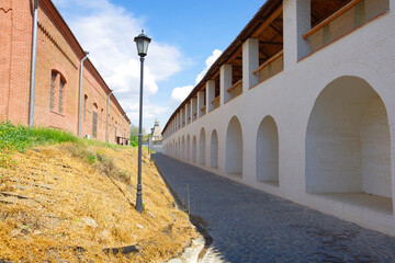 Wall Mural - Astrakhan, Russia. View of the old tower with a wooden roof and a long white wall in the Astrakhan Kremlin.