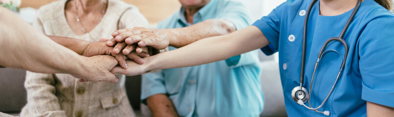 Wall Mural - Panoramic banner background of elderly human bare hands join together in the middle under with indoors light. Concept Elderly nursing care help and support. Service mind for senior people.