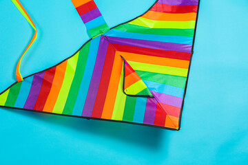 Wall Mural - Bright rainbow kite on light blue background, top view