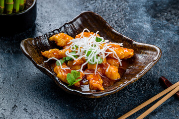 Wall Mural - Shrimp in sweet sour sauce on dark stone table