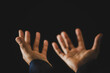 © doidam10 - Hand folded prayer to god on dark in church concept for faith, spirituality and religion, woman person praying on holy bible in morning. Christian catholic woman hand with worship in black background.