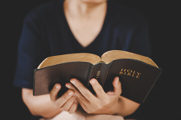 Young woman person hand holding holy bible with study at home. Adult female christian reading book in church. Girl learning religion spirituality with pray to god. concept of student education faith.