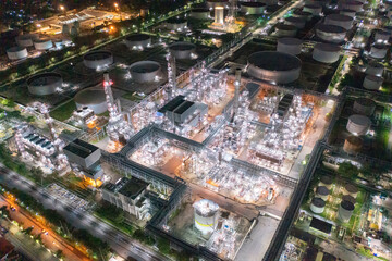 Poster - Aerial view of petrochemical oil refinery and sea in industrial engineering concept in Bangna district at night, Bangkok City, Thailand. Oil and gas tanks pipelines in industry. Modern metal factory.