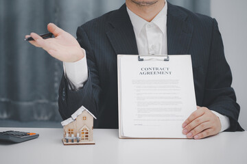 Wall Mural - Real estate agent showing contract agreement at office. Home sales and home insurance concept.