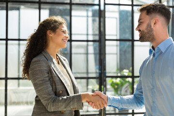 Poster - Business people shaking hands, finishing up a meeting.