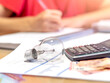 Unrecognisable Woman calculating expenses. Selective focus.
