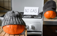 Pumpkins In Winter Hats On Halloween At Cold Home, No Gas