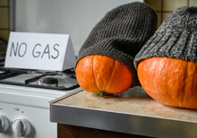 Pumpkins In Winter Knit Hats On Halloween At Cold Home, Expensive Gas And Electricity For Heating