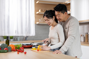 Wall Mural - Loving korean woman cooking for her husband