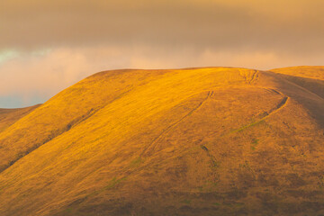 Wall Mural - Sunset over green hills in North UK.