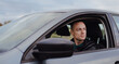 © antgor - Driver serious man riding his car, shot from outside