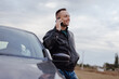 © antgor - Confident young successful man talking by phone standing near his car