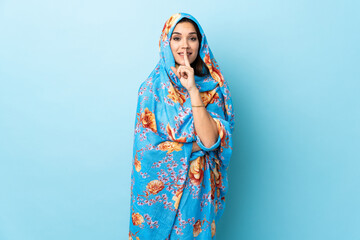 Sticker - Young Moroccan woman with traditional costume isolated on blue background showing a sign of silence gesture putting finger in mouth