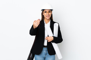 Canvas Print - Young architect caucasian woman with helmet and holding blueprints over isolated background inviting to come