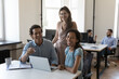 © fizkes - Happy business coworkers at laptop, diverse office employees at shared workplace corporate portrait. Successful multiethnic team working on project together, looking at camera, smiling, laughing