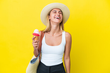 Wall Mural - Blonde Uruguayan girl in summertime holding ice cream isolated on yellow background laughing