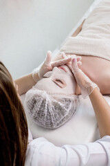 Wall Mural - Woman in moisturizing anti-wrinkle mask. A woman is lying down, resting in a beauty salon. SPA procedures at home or in a cosmetology center