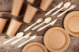 Fototapeta Tulipany - Disposable paper biodegradable cups, plates, spoons, forks and knives