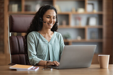 Wall Mural - Cheerful brunette woman having online job interview from home