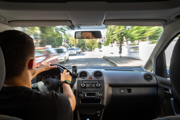 Wall Mural - Hands on the wheel when driving at high speed from inside the car.