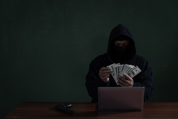 Black Hat Hacker Counting Banknote While Hacking Information From Bank. Cyber Security Concept