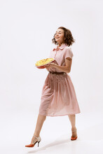 Portrait Of Beautiful Cheerful Woman Walking With Apple Pie Isolated Over White Background. Visiting Neighbours