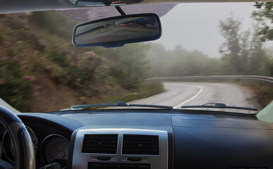 Canvas Print - View from the car on a wet winding road