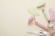 © New Africa - Gua sha tools, facial rollers and dropper on beige background, flat lay. Space for text