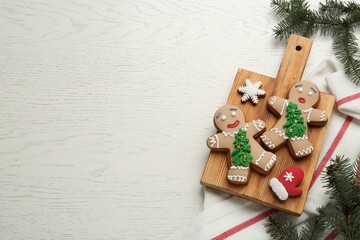 Wall Mural - Delicious Christmas cookies and fir branches on white wooden table, flat lay. Space for text