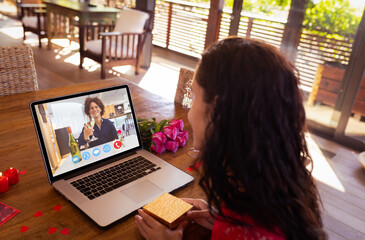 Poster - Happy biracial young couple dating on video call through laptop during valentine day