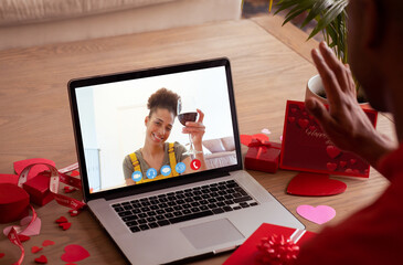 Sticker - Smiling biracial young woman with red wine during online dating with boyfriend on valentine day