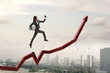 © Sergey Nivens - Business person climbing on red graph arrow