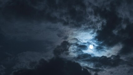Wall Mural - nighttime timelapse. there is a full moon and black clouds in the sky. beautiful moonlight and twink