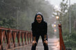 Asian ladies running in the rain she is tired
