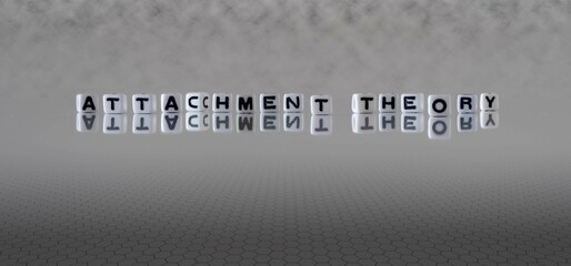 attachment theory word or concept represented by black and white letter cubes on a grey horizon background stretching to infinity