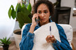 © Drobot Dean - Young woman while holding pregnancy test and talking on cellphone
